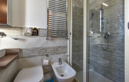 a bathroom with a toilet and a sink and a shower at Lovely Home In Linguaglossa With Wifi in Linguaglossa