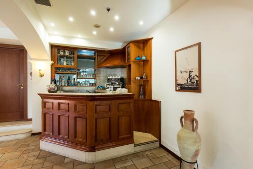a kitchen with a counter and a vase in a room at Hotel Trevi Riccione in Riccione