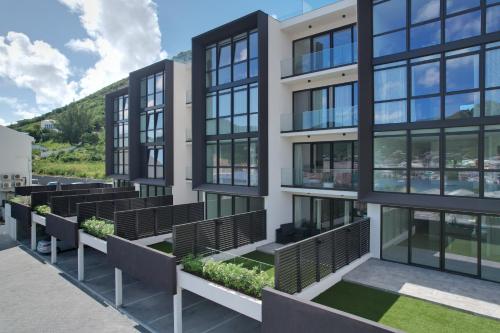 an exterior view of a building with black windows at The Hills Residence in Simpson Bay