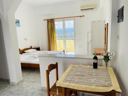 a room with a table with a bottle of wine at PROFILIO Apartments & Studios in Exopoli