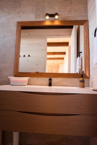 a bathroom with a sink and a mirror at Espectacular Casa Palafito frente al mar in Pichilemu