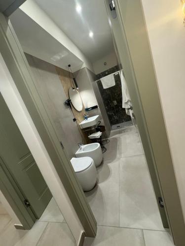 a bathroom with a toilet and a sink at La Stella Di Napoli B&B in Naples