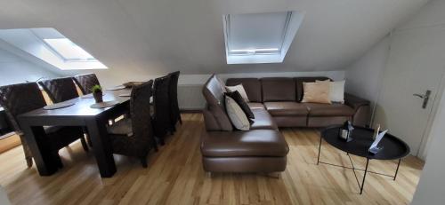 a living room with a couch and a table at Ferienhaus Am Reilsbach in Cochem