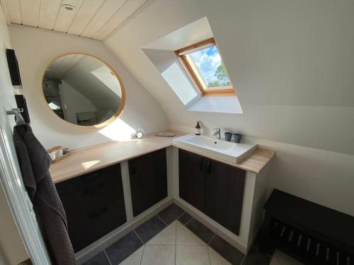 a small bathroom with a sink and a mirror at Wonderful house & garden in Tommerup