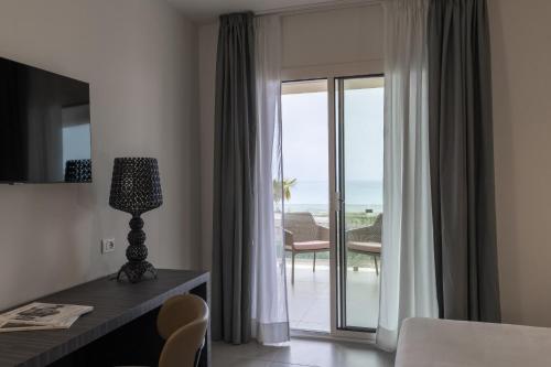 a hotel room with a view of the ocean at Resort La Battigia Beach & Spa in Alcamo Marina