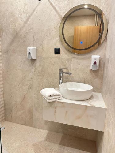 a bathroom with a sink and a mirror at Hotel Suljovic in Sarajevo