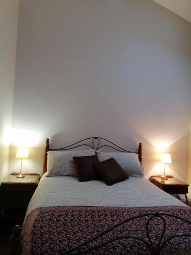 a bedroom with a large bed with two lamps at The Beeches in Newry