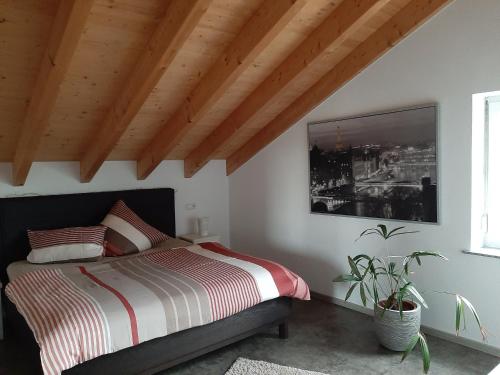 a bedroom with a bed and a painting on the wall at FeWoHerrmann in Gundelsheim