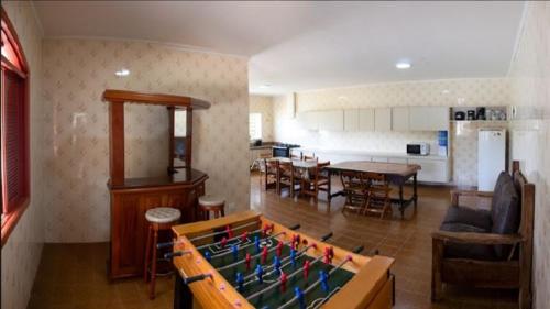 a living room with a large pool table in the middle of a room at Elysian Place in Atibaia