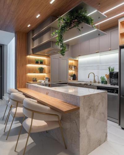 a kitchen with a large marble counter and stools at Brown House in Kertapati