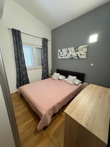 a bedroom with two beds and a window at Apartment Pupina in Žrnovnica
