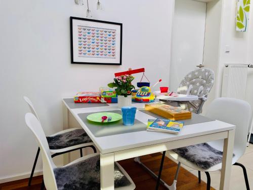 a dining room table with a white table and chairs at 2-Zi. Apartment 42 qm, an der Friedrichsau/Messe in Neu Ulm