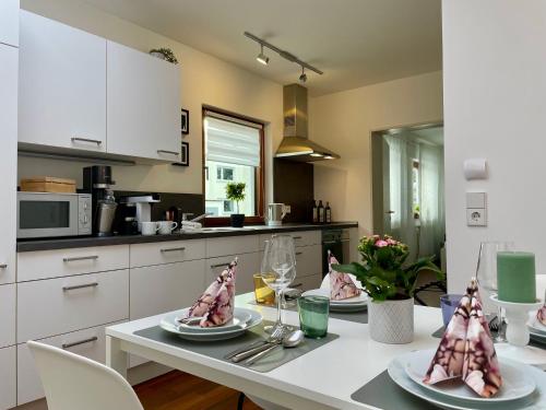 a kitchen with a table with plates of food on it at 2-Zi. Apartment 42 qm, an der Friedrichsau/Messe in Neu Ulm