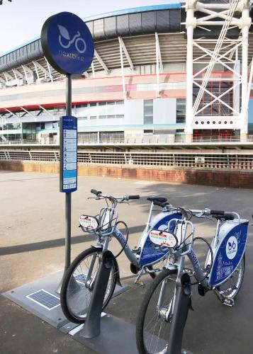 two bikes parked next to a sign in front of a stadium at 1 Fitzhamon Embankment APARTMENTS opposite Principality Stadium - LONG STAY OFFER in Cardiff