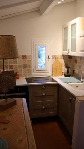 uma cozinha com um lavatório e uma janela em La sauvagine em Saintes-Maries-de-la-Mer