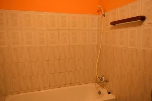 a bathroom with a bath tub with a shower at Room in BB - Amahoro Guest House - Queen Room in Ruhengeri