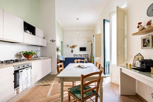 cocina y comedor con mesa y sillas en MARIDDA - Sicilian Vacation Home, en Giarre