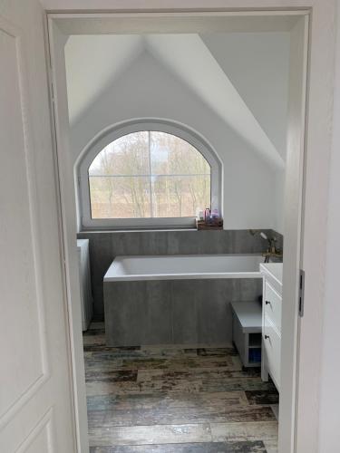 a bathroom with a bath tub and a window at Żałesisko in Rypin