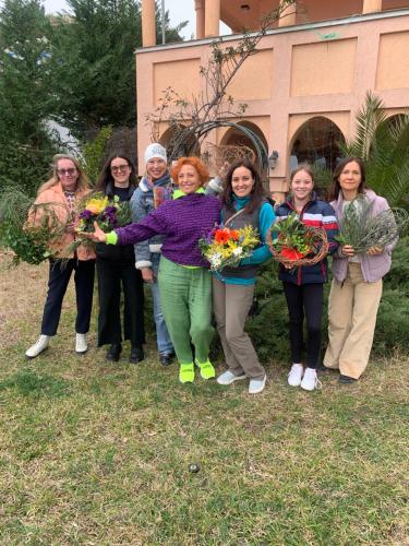 a group of women holding flowers in front of a building at Maroccana in Dobra Voda