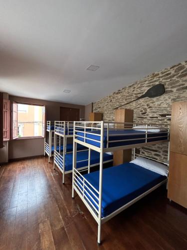a group of bunk beds in a room at Albergue Mayor in Sarria