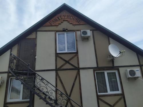 a building with a window and a balcony at Family House in Makarovka