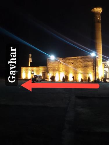 a car parked in front of a building at night at Gavhar House in Khiva
