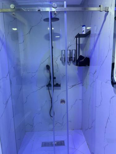 a bathroom with a shower with a glass door at Appartement Wow in Al Hoceïma