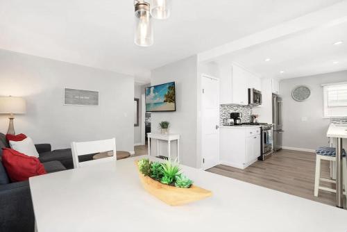 a white living room with a couch and a table at Balboa Paradise - Renovated Coastal Haven in Newport Beach