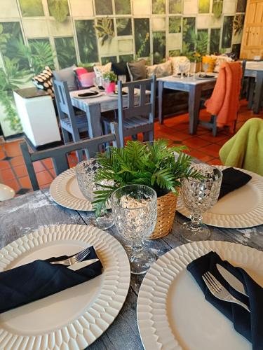 a table with white plates and napkins on it at Hotel Margarita Village in Porlamar