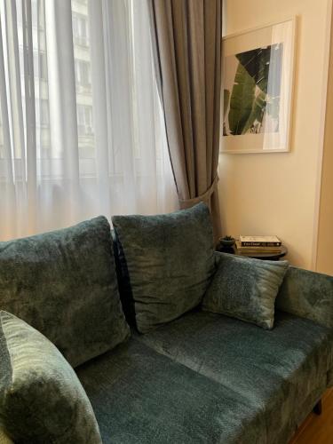 a couch in a living room with a window at RED RIDING HOOD in Belgrade