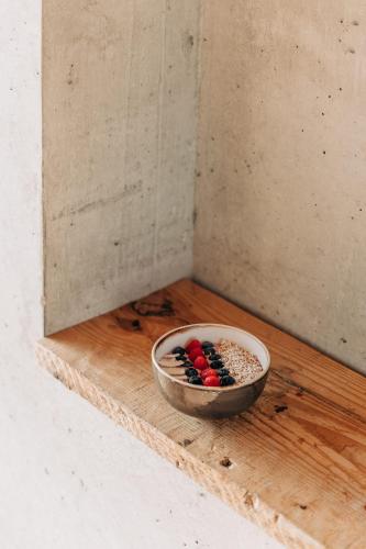 a bowl of chocolates sitting on a wooden table at Bauernchalet elbacher gütel - Exklusives Ferienhaus am Starnberger See in Eurasburg
