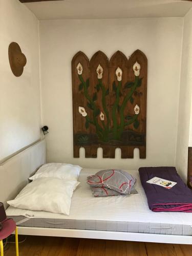 un lit dans une chambre avec un tableau sur le mur dans l'établissement Gîte de la perge haute, à Vals-les-Bains