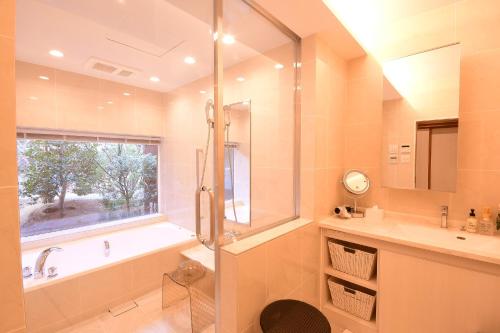 a bathroom with a shower and a tub and a sink at Koyasan Sanadabo Rengejoin in Koyasan