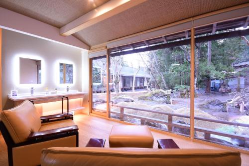a living room with a large window and a couch at 高野山 真田坊 蓮華定院 -Koyasan Sanadabo Rengejoin- in Koyasan