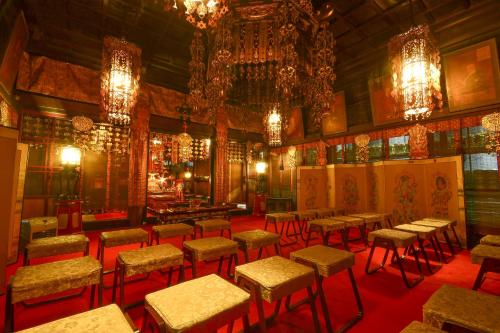 a room with chairs and tables and chandeliers at Koyasan Sanadabo Rengejoin in Koyasan