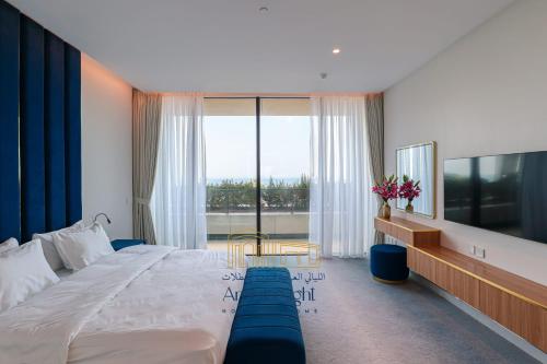 a bedroom with a large bed and a large window at Arabian Nights - Oceanfront Luxurious Living at Atlantis The Royal in Dubai