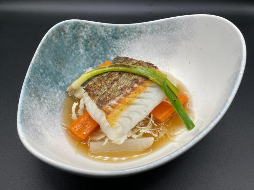 a plate of food with a piece of fish and carrots at Hotel Restaurant Santiago in Hendaye