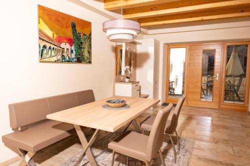 a dining room with a wooden table and chairs at Bürgerhaus Martinecz in Bad Radkersburg