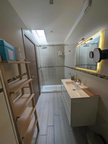 a bathroom with a sink and a shower at Golden Suite Apartments in Matera