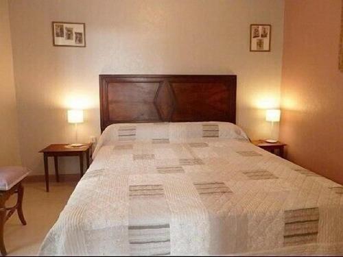 a bedroom with a large bed with two tables at GITE DU VIGNERON in Chassey-Le-Camp