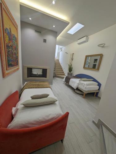 a large room with two beds and a fireplace at Golden Suite Apartments in Matera