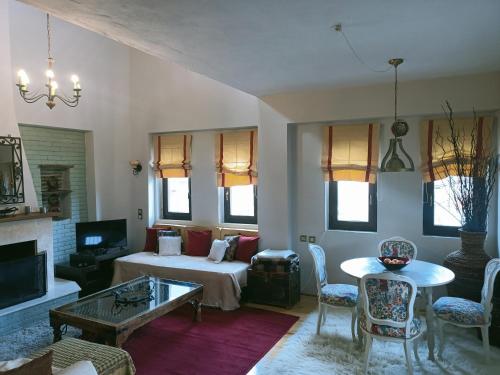 a living room with a couch and a table at Amadrias Villa Florina in Florina