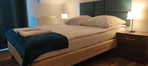 a large bed with two pillows on top of it at Apartamenty Koło Brzegu in Gąski