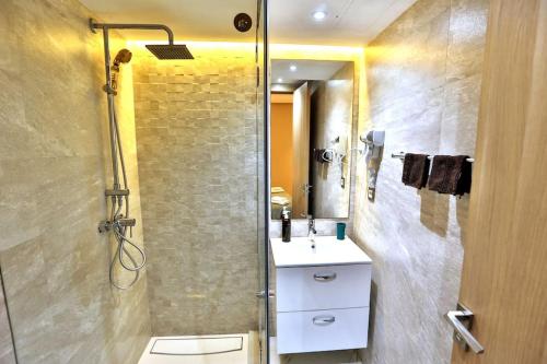 a bathroom with a shower and a sink and a toilet at Anfa Flores in Casablanca