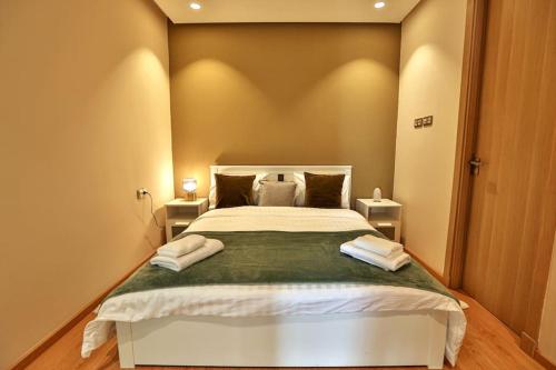 a bedroom with a large bed with two night stands at Anfa Flores in Casablanca