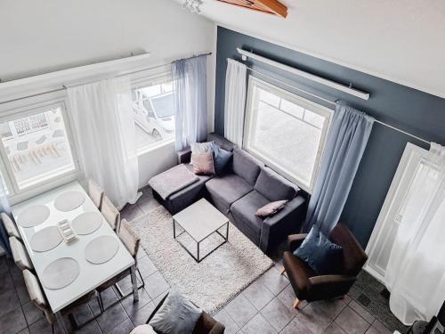 a living room with a couch and a table at Party condo in the center of Levi in Levi