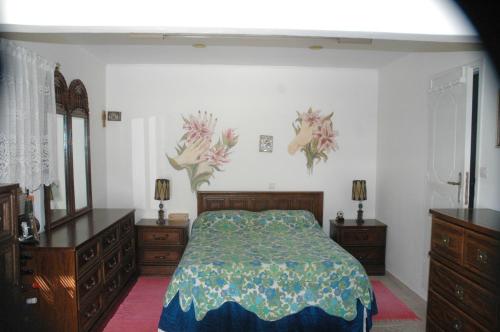 a bedroom with a bed and two dressers at Mare - Mare B in Patra