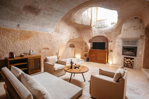 a living room with a couch and a table at Millstone Cave Suites Hotel in Uçhisar