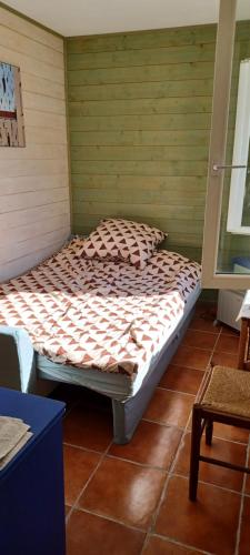 uma cama sentada num canto de um quarto em L'Escale em Blagnac
