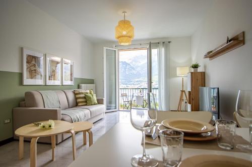 a living room with a couch and a table at [ONNO] Il balcone vista lago - vicino a Bellagio in Onno